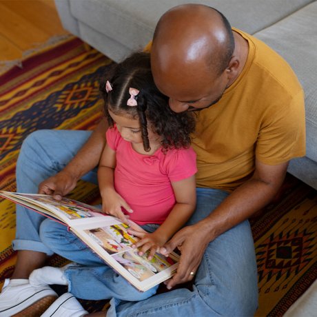 father daughter sit reading